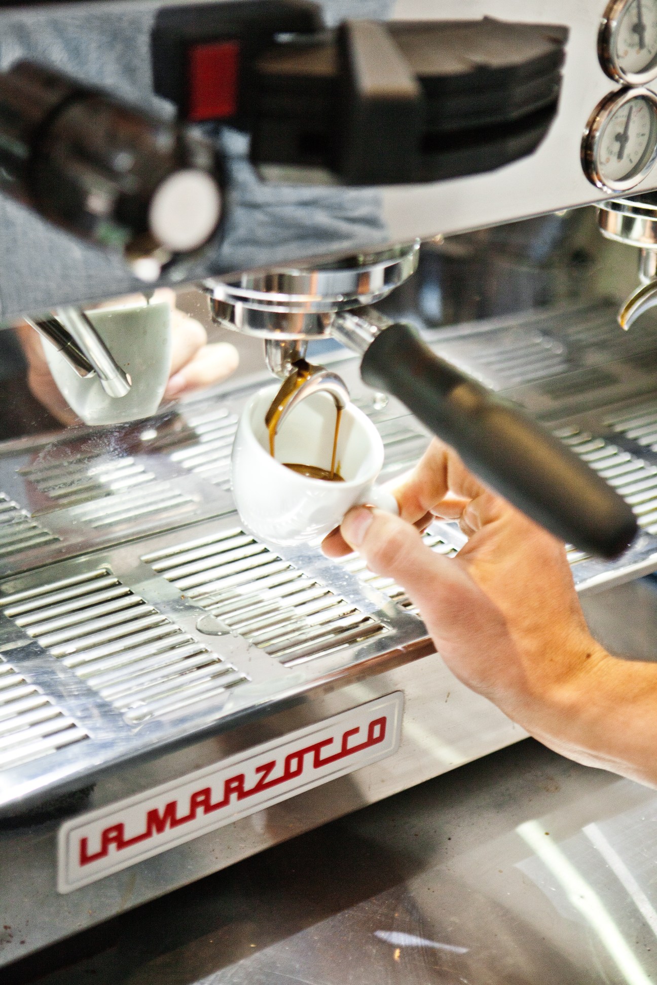 Espresso being poured into a white cup on a La Marzocco machine at Ten Belles