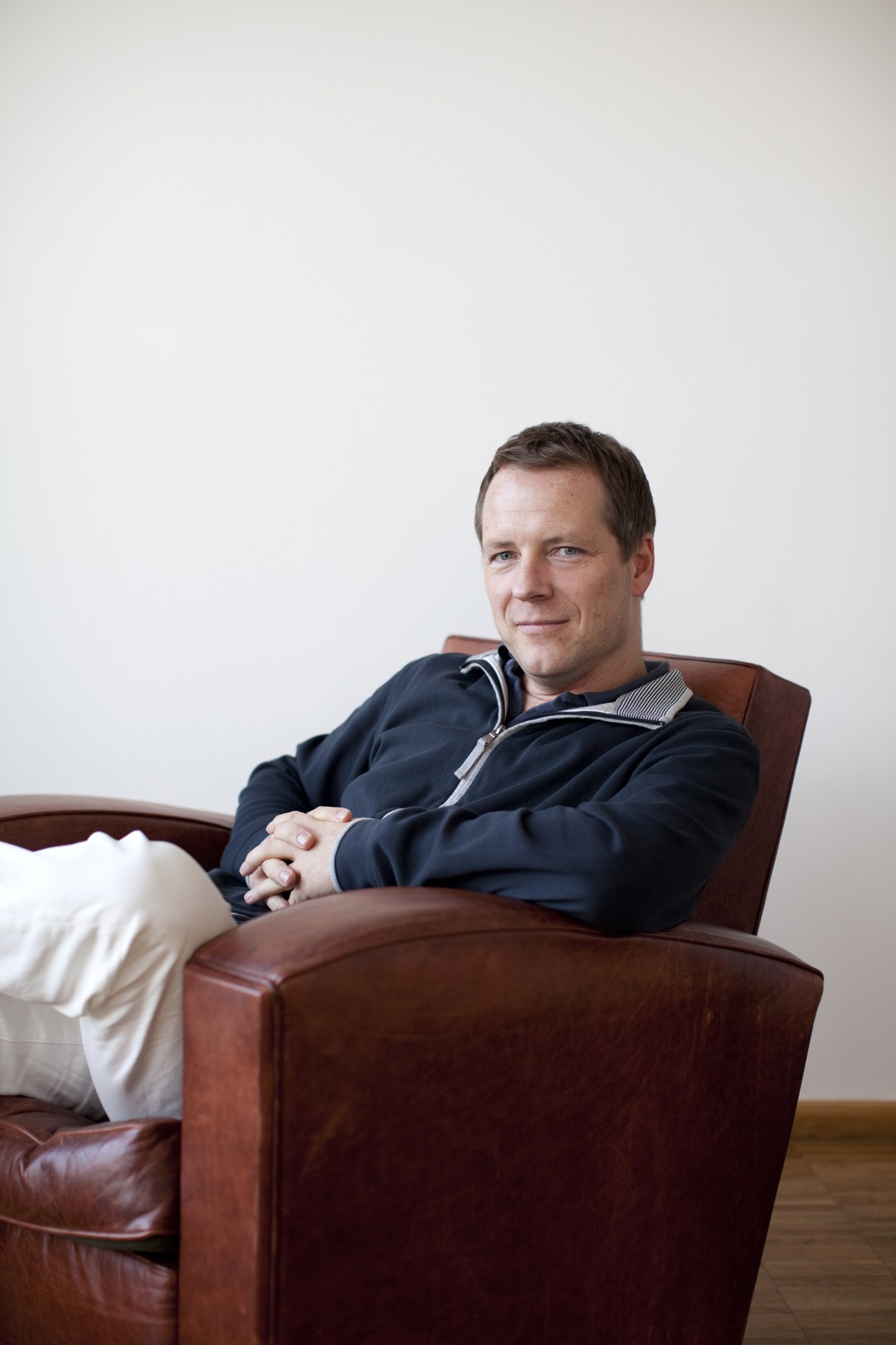 Christian Wegerhoff, CEO of internet company Mediaworx, seated in a brown leather chair.