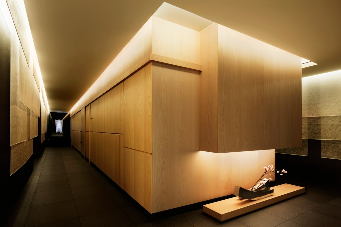 Modern spa interior with wooden panels, ambient lighting, and minimalist design at Kanebo Sensai Select spa.