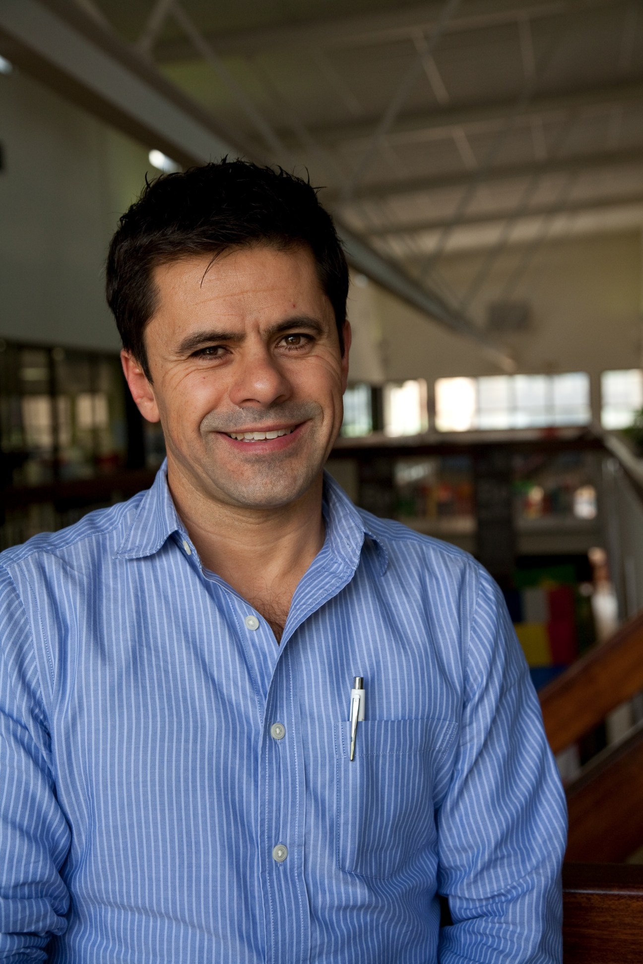 Tex Texeira, head of production at SuperSport, smiles at camera in blue striped shirt
