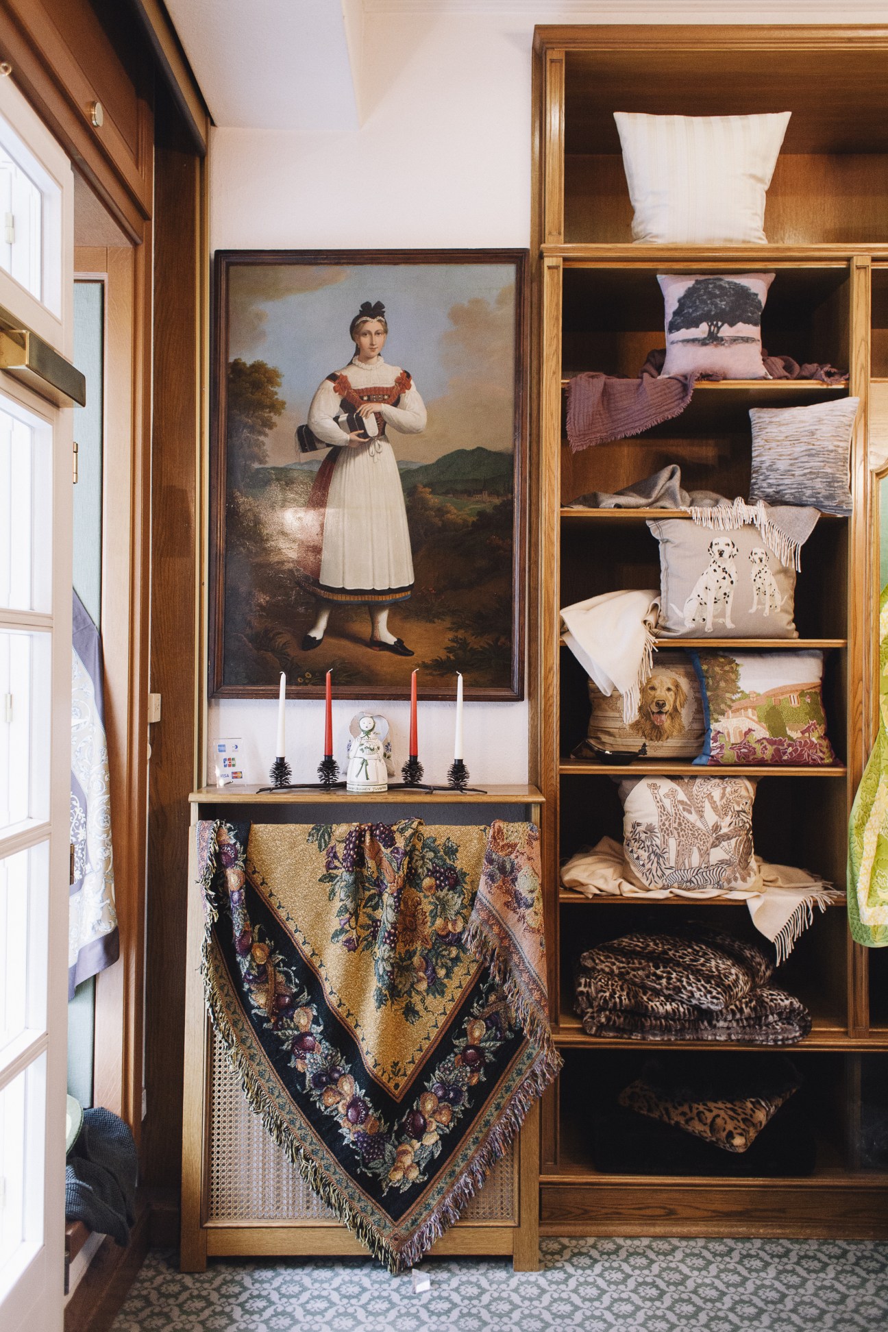 Interior of Zur Schwäbischen Jungfrau homeware shop displaying hand-crafted linens, cushions and blankets on wooden shelves.