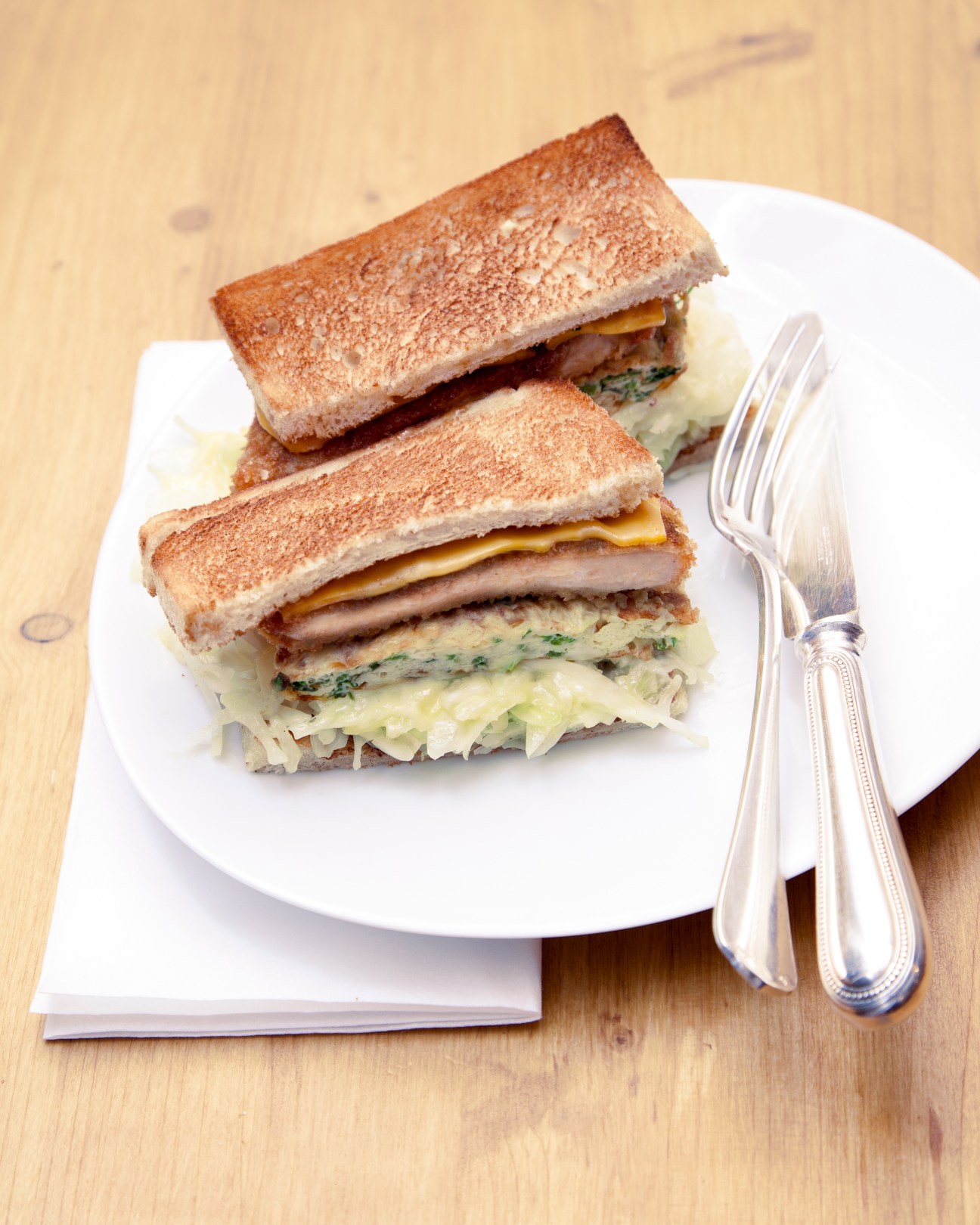 Tonkatsu sandwich with breaded pork cutlet, cheese, and greens on toasted bread at Abri, Paris.
