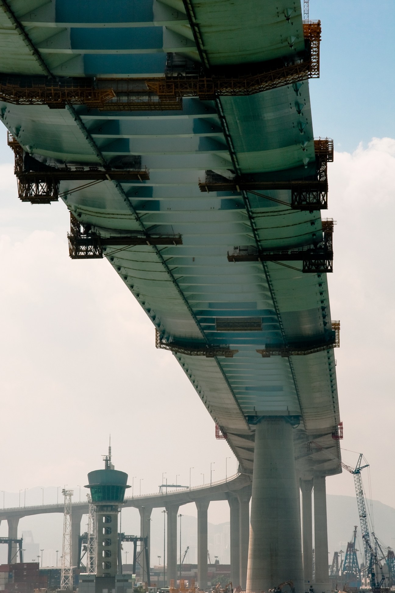 Upward view of Stonecutters Bridge's 300m tower with dual vehicle decks and stay cables in Hong Kong.
