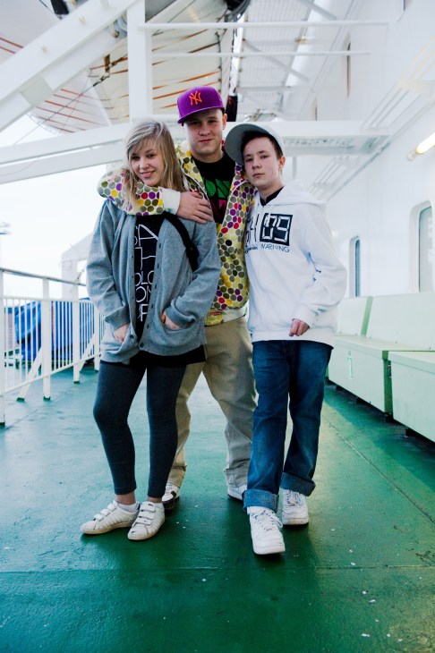 Three young passengers pose together on the M/S Gabriella ferry deck.