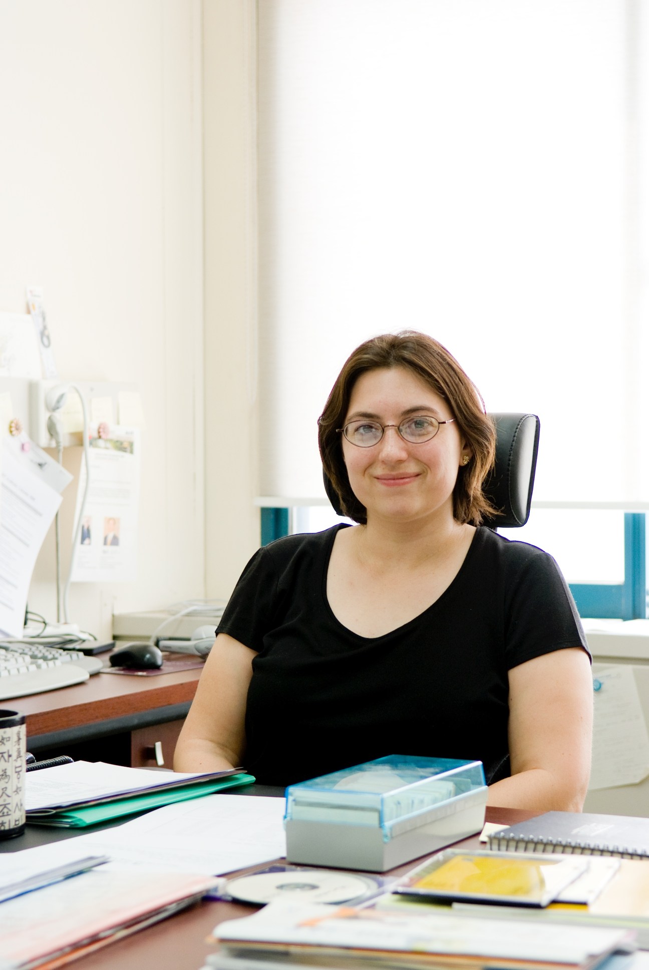 Kate Thompson, assistant professor of engineering, sitting at her desk in an office.