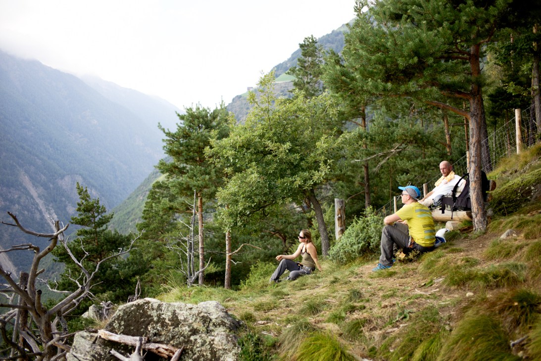 Bergwelten editor Klaus Haselböck and creative director Markus Kietreiber hiking in a forested Alpine valley in South Tyrol.