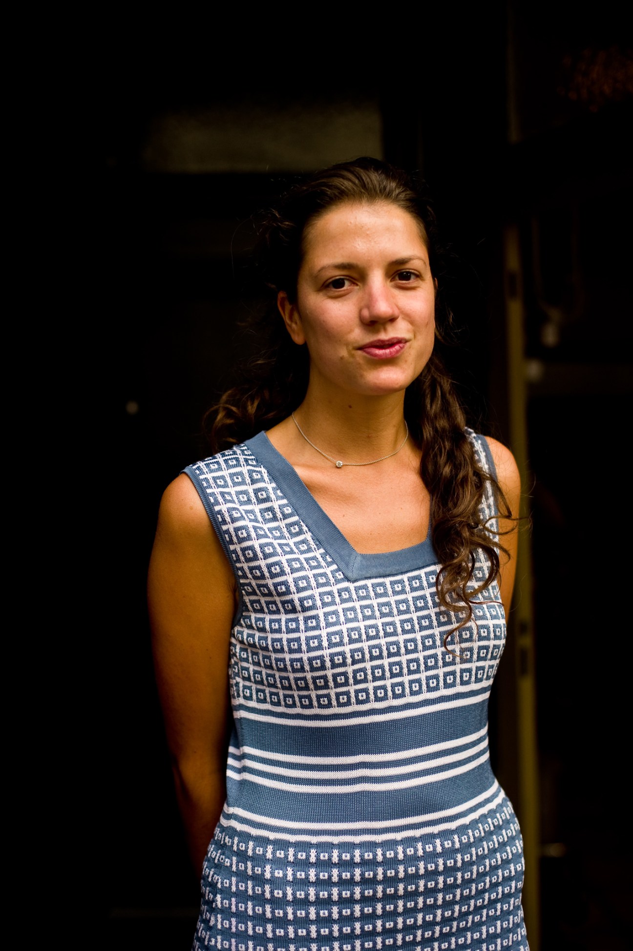 Maïta Muijres, owner of vintage clothing shop Belchique on De Kloosterstraat in Antwerp, wearing a patterned blue and white dress.