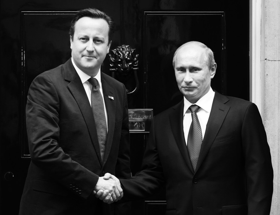 David Cameron and Vladimir Putin shake hands in formal black and white photograph.