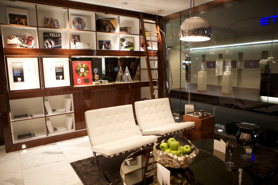 Carl F Bucherer stand at BaselWorld featuring wood cabinetry, display cases, and modern furnishings.