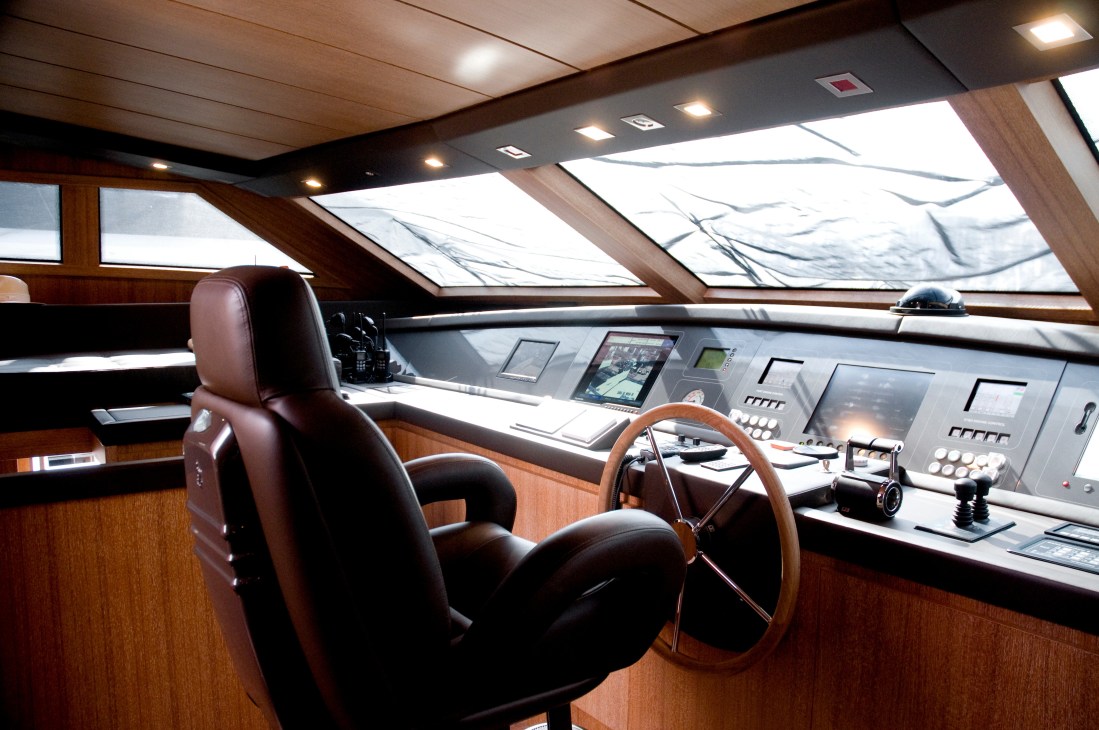 Captain's deck on San Lorenzo 33m yacht 'Keep Cool' with wooden steering wheel and control panel.