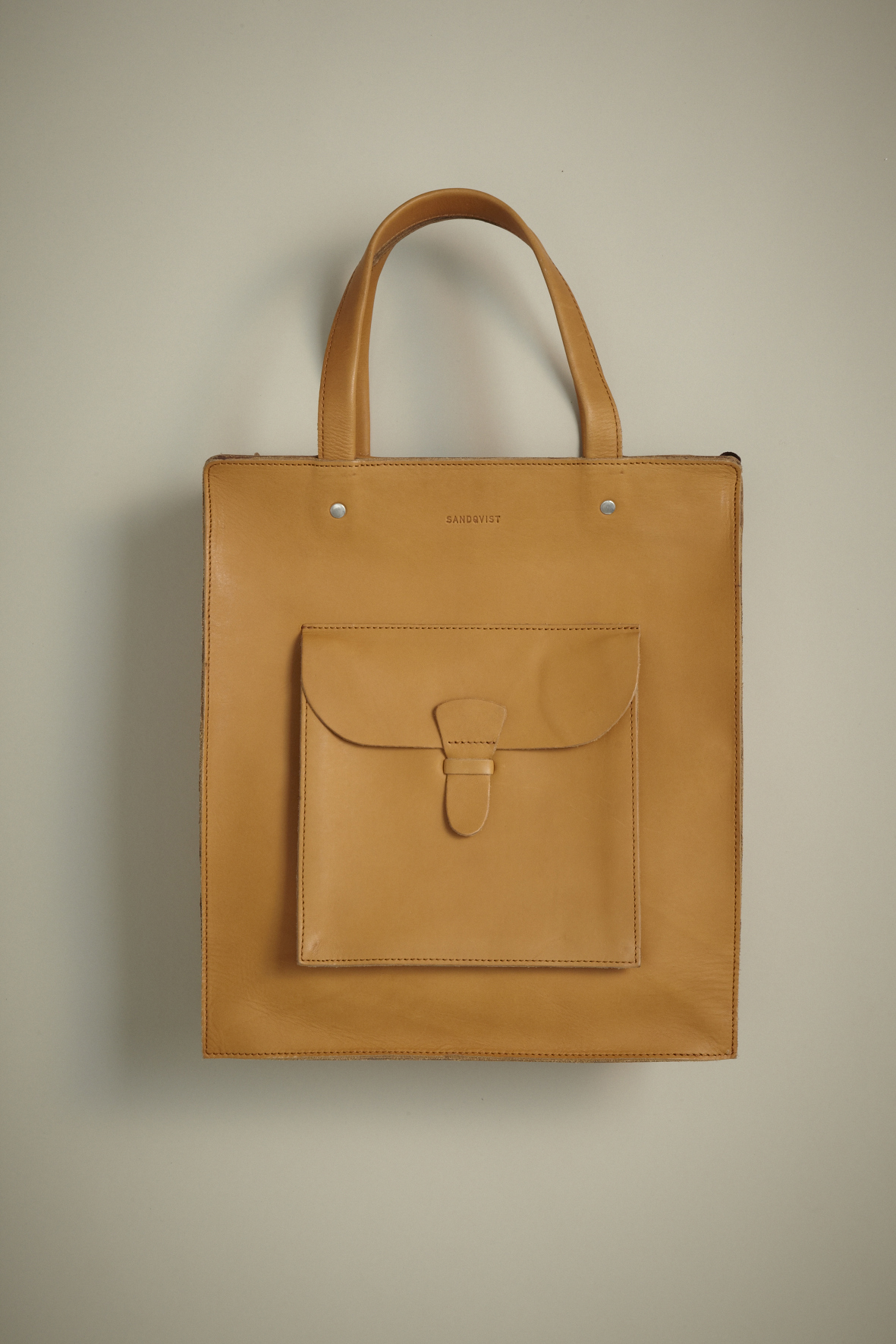Tan leather tote bag by Sandqvist with vegetable-tanned leather and structured design.