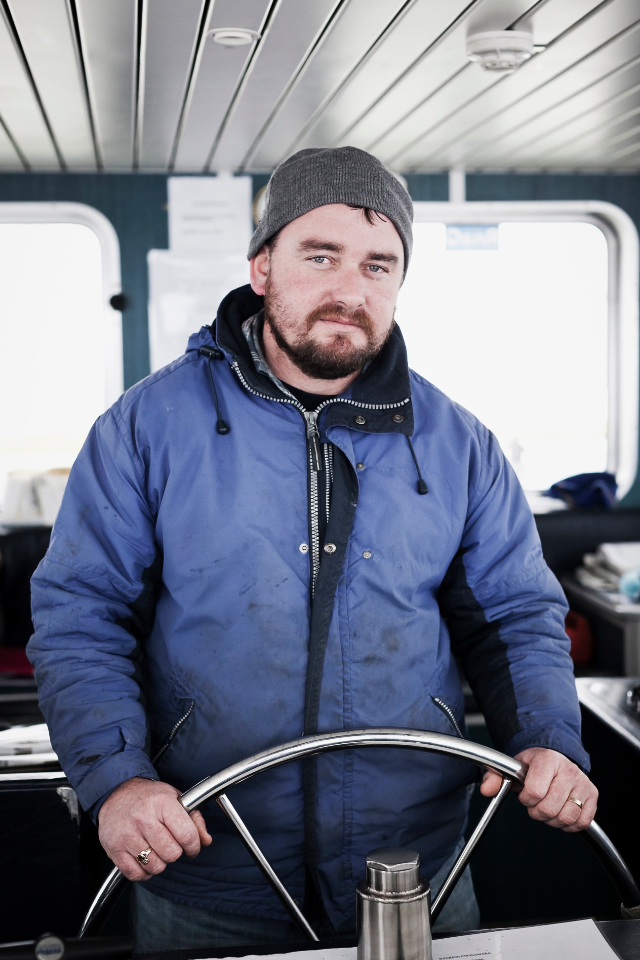Martin O'Donnell at the helm of a ferry boat connecting Inis Méain island to mainland Ireland.