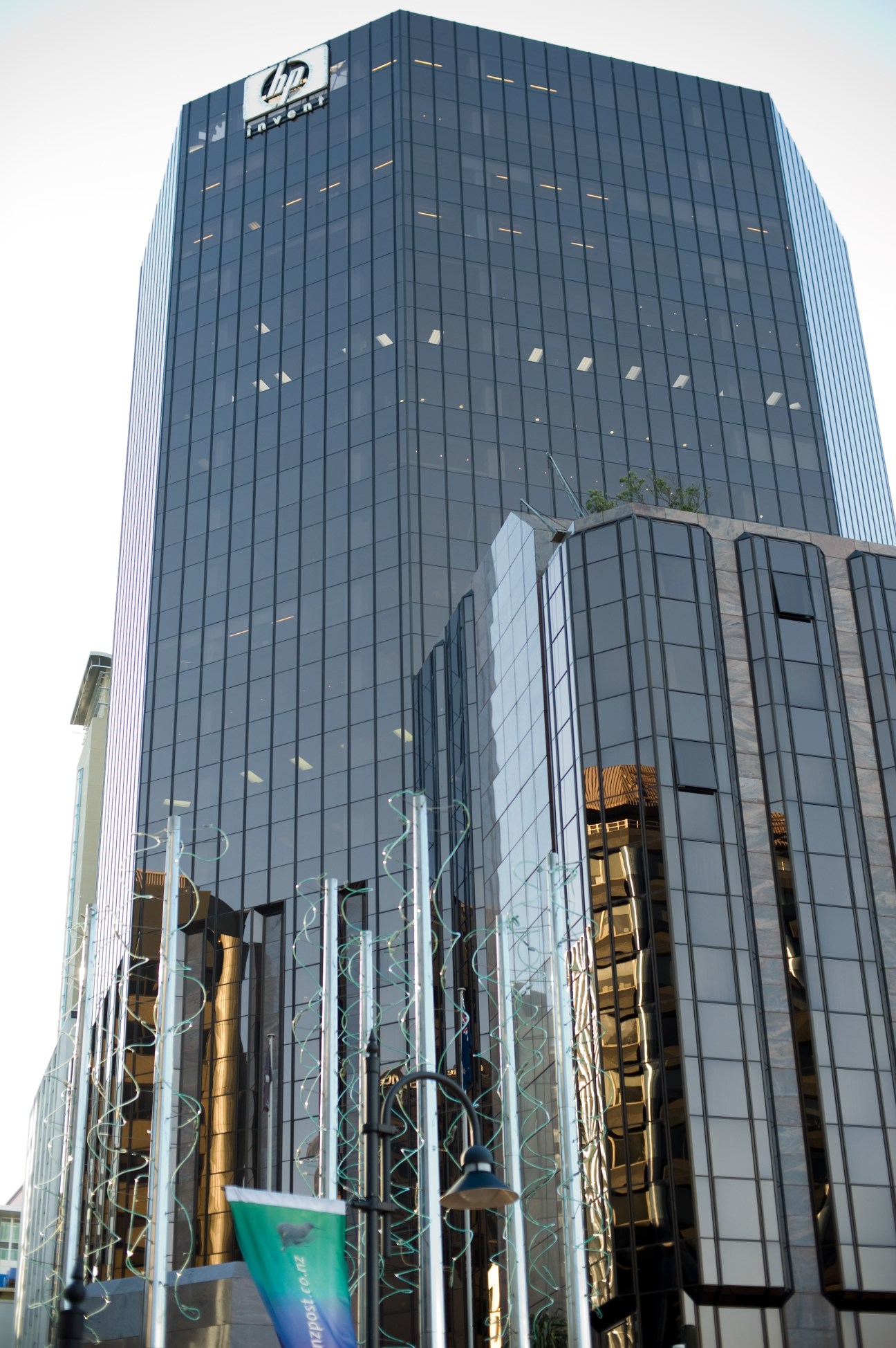 HP Tower in Wellington, a tall modern office building with dark glass facade housing JP Morgan and BNP Paribas.
