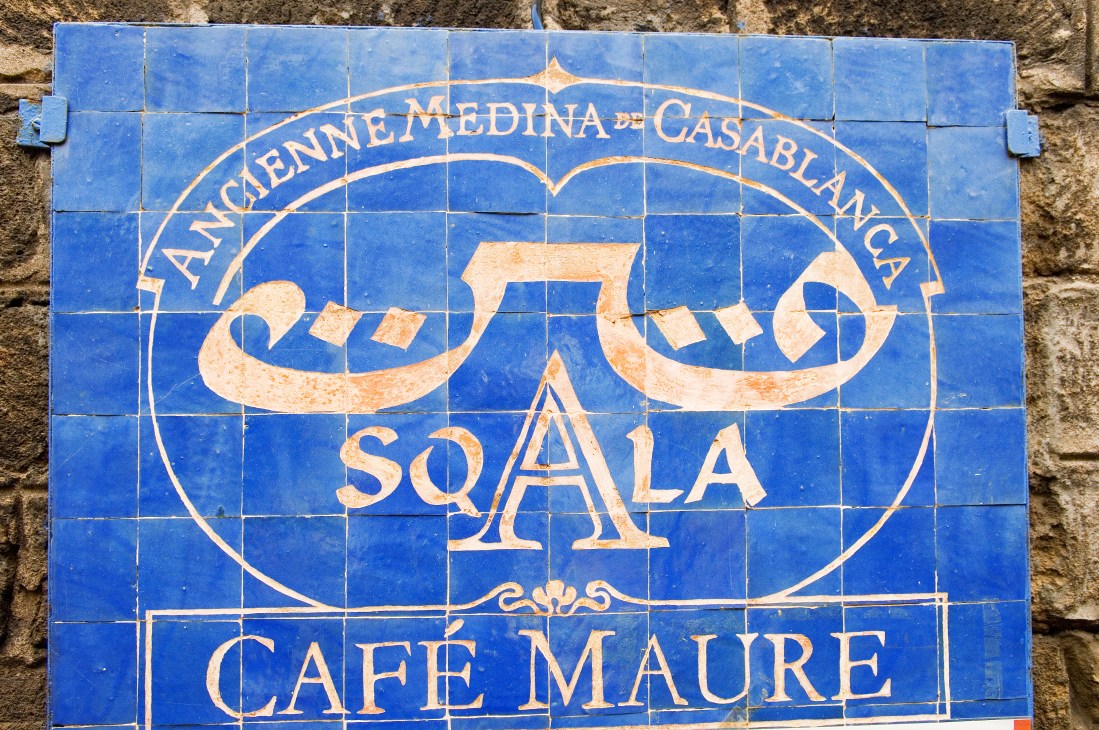 Blue and cream tilework sign for La Sqala café reading "Ancienne Medina de Casablanca" with decorative Arabic calligraphy.
