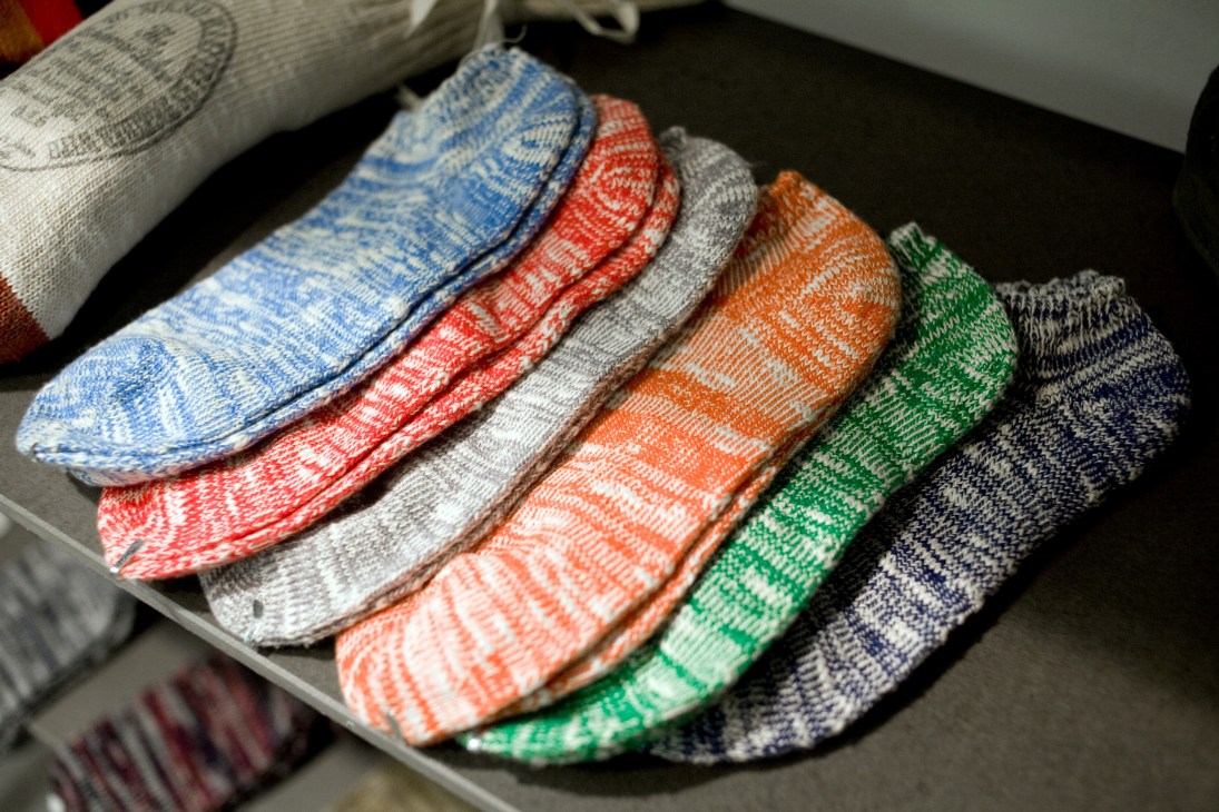 Colorful patterned socks by Riding High displayed in a row on a dark surface.