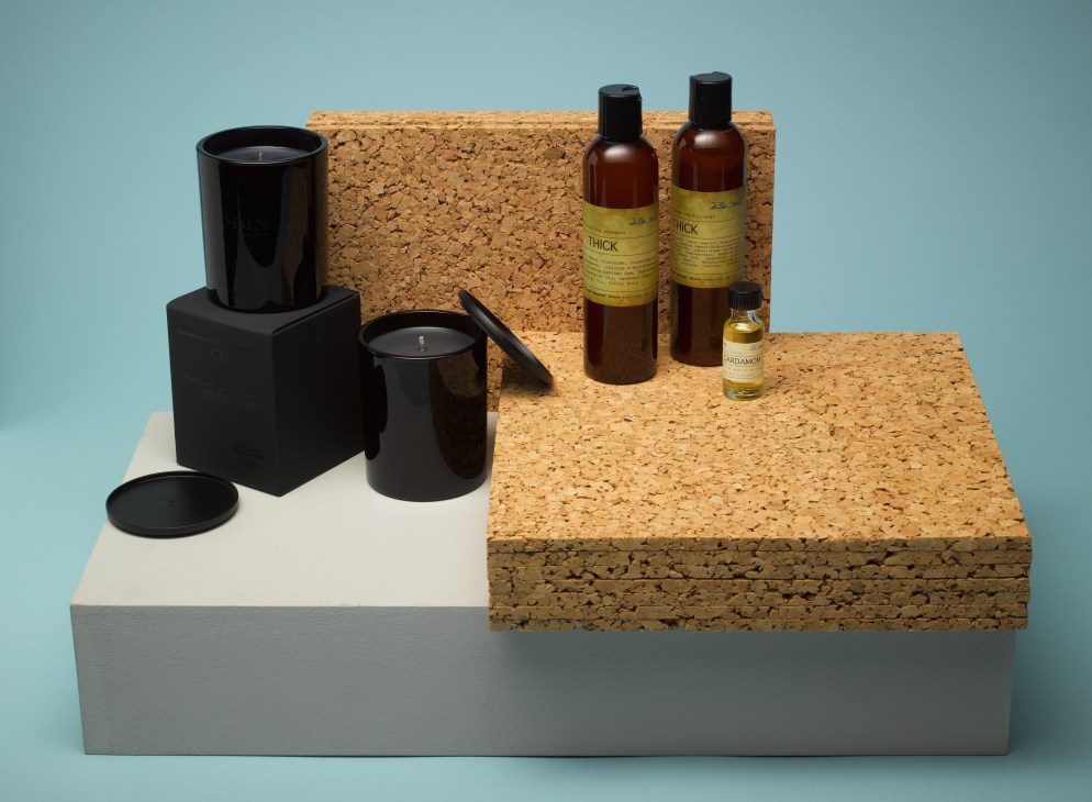 Odin candles and Portland General beauty products displayed on cork platforms against a blue background.