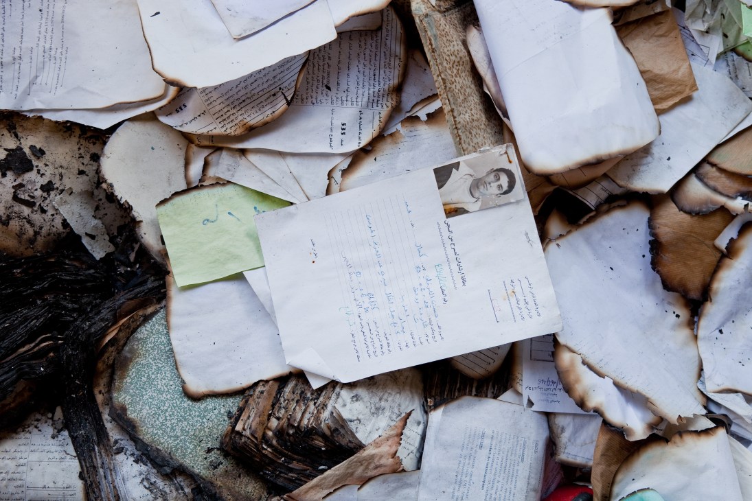 Personal files and documents scattered on the floor of a ransacked police station in La Goulette, Tunisia.