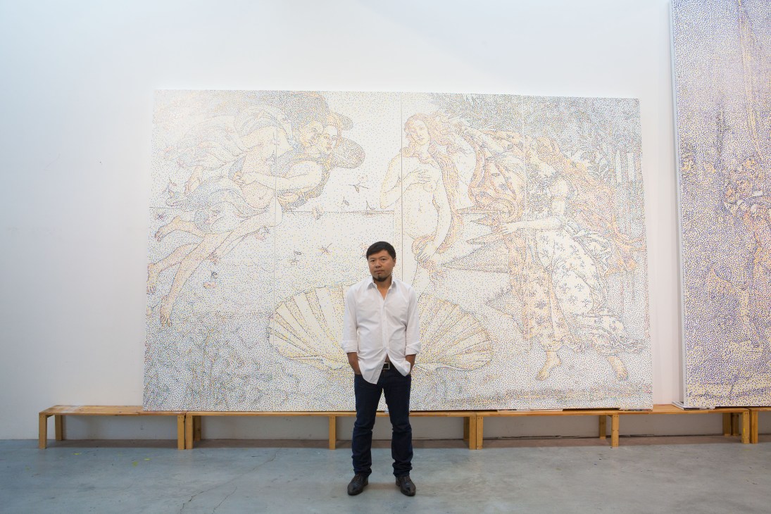 Chengdu artist Yang Mian standing in front of a large abstract artwork with delicate line drawings.