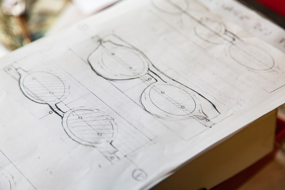 Pencil sketches of eyeglass frames with oval lenses drawn by Pierre Hibon on lined paper.