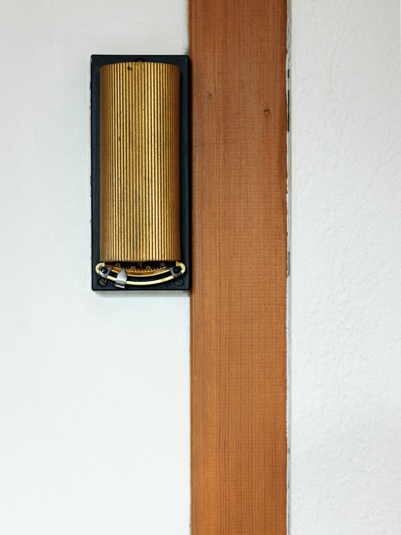 Brass thermostat with vertical ribbed gold face and curved gauge scale designed by Knut Knutsen.