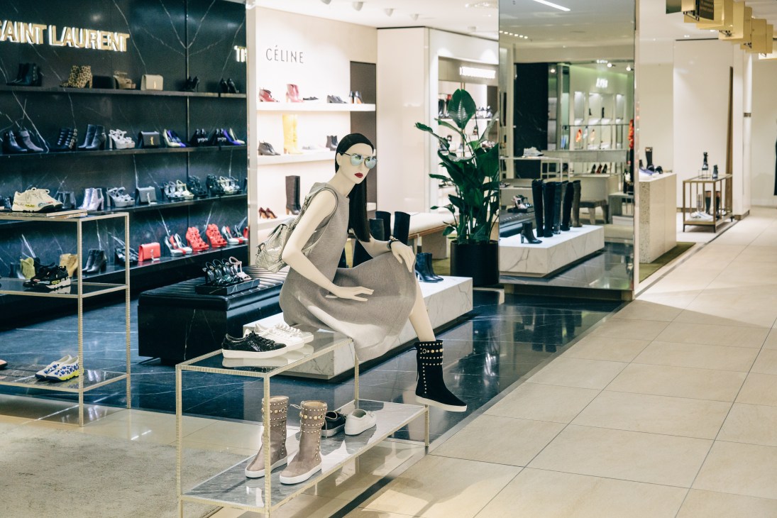 Kadewe department store shoe section with luxury brand displays and a mannequin modeling footwear.