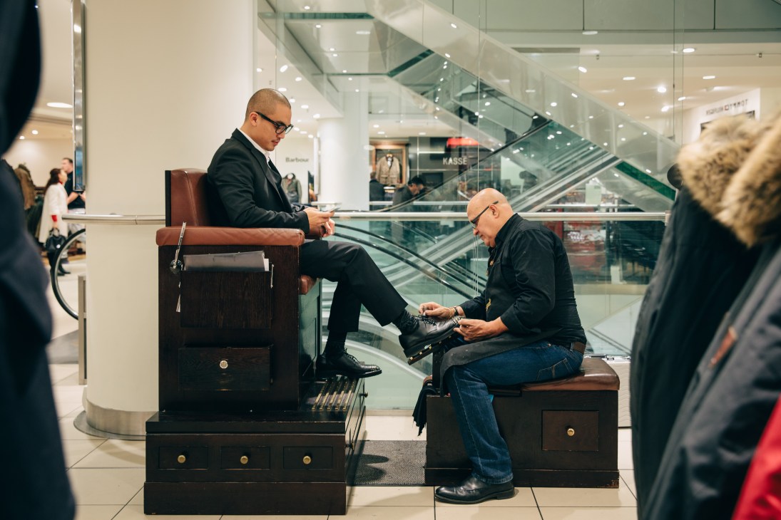 Shoe specialist Valentin Zamora Lopez assists a customer at Kadewe department store.