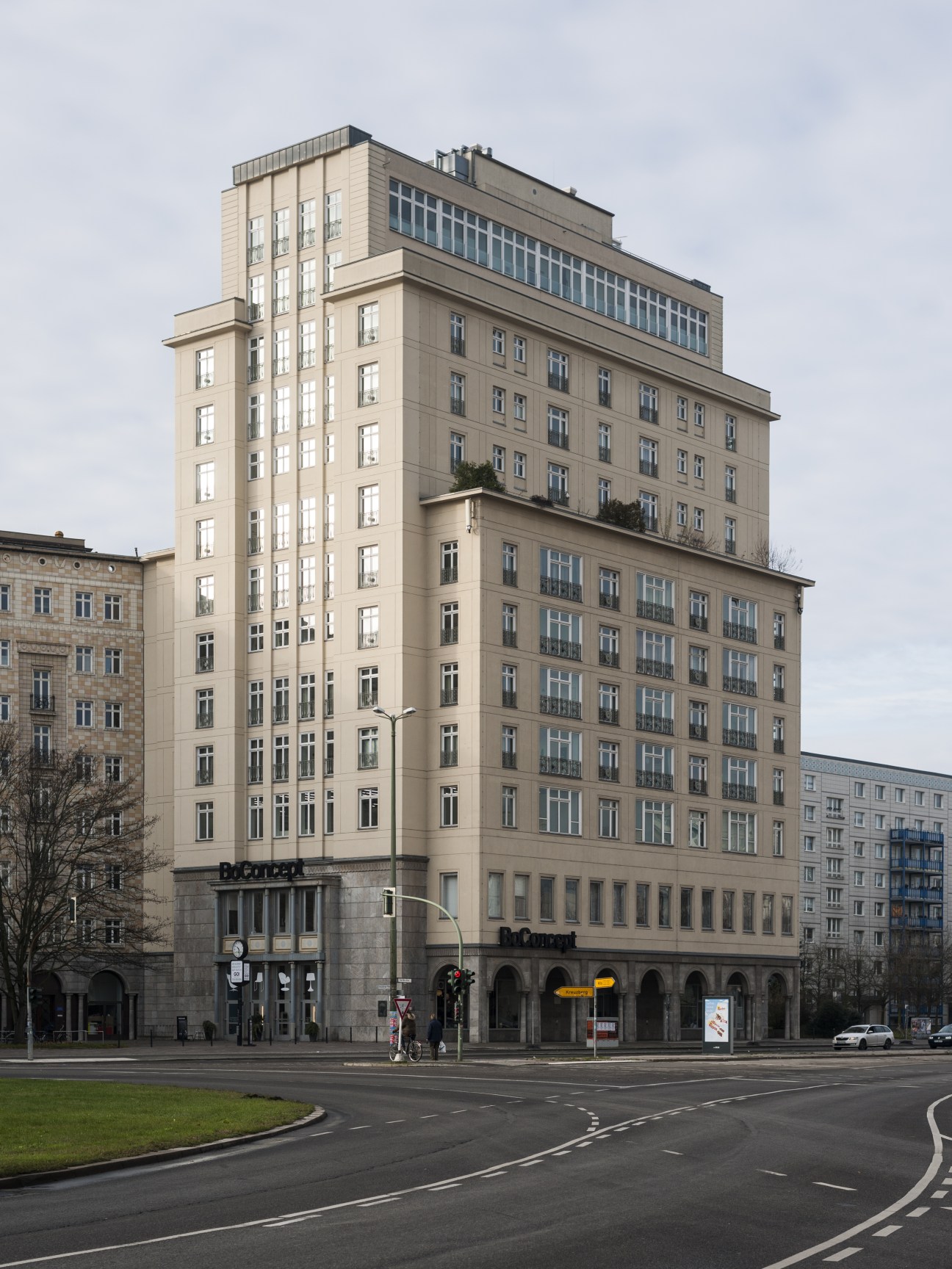 Henselmann Tower, a 14-storey socialist-realist apartment building in Berlin with cream-colored facade and symmetrical windows.