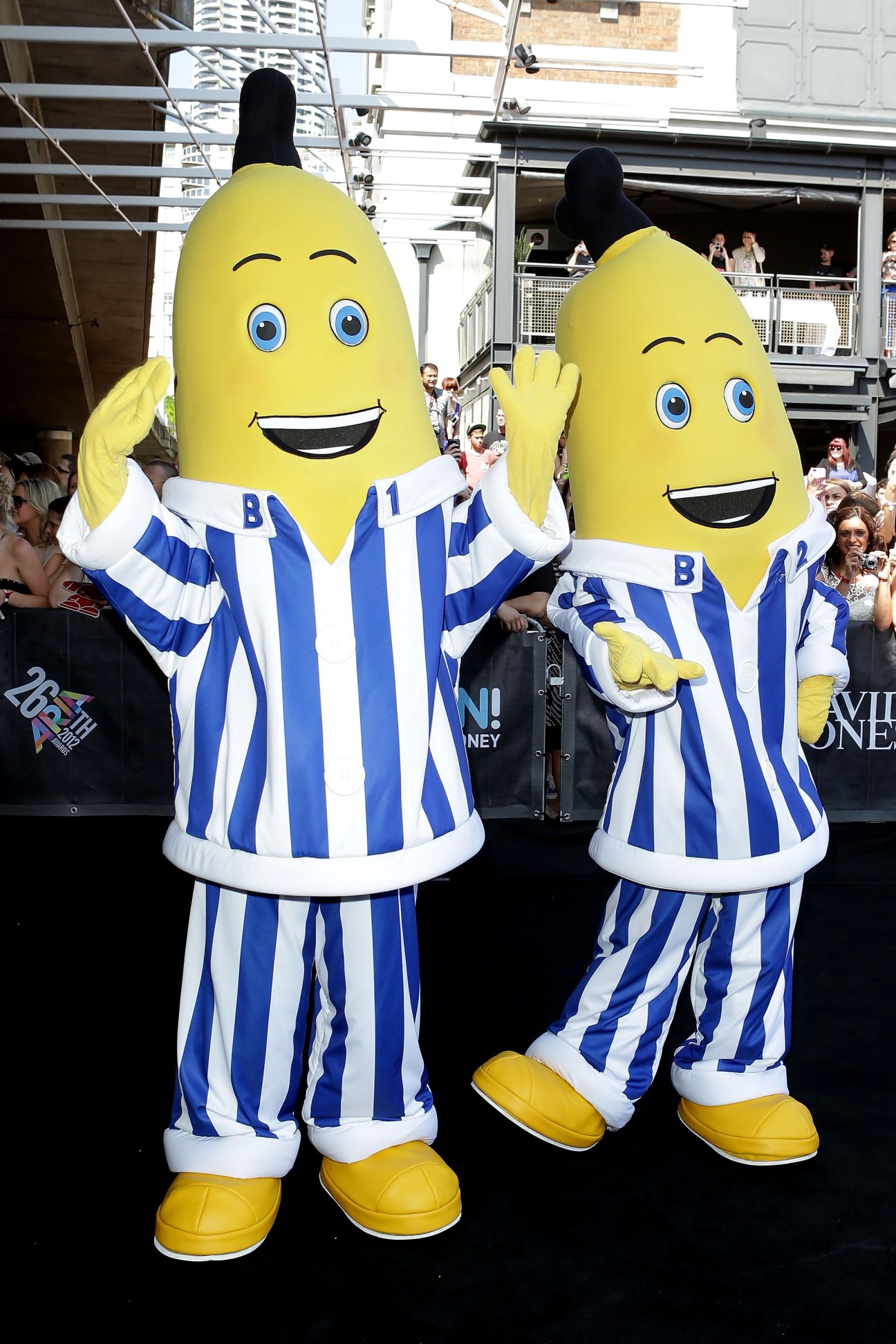 Two Bananas in Pyjamas characters in blue and white striped costumes at a public event.