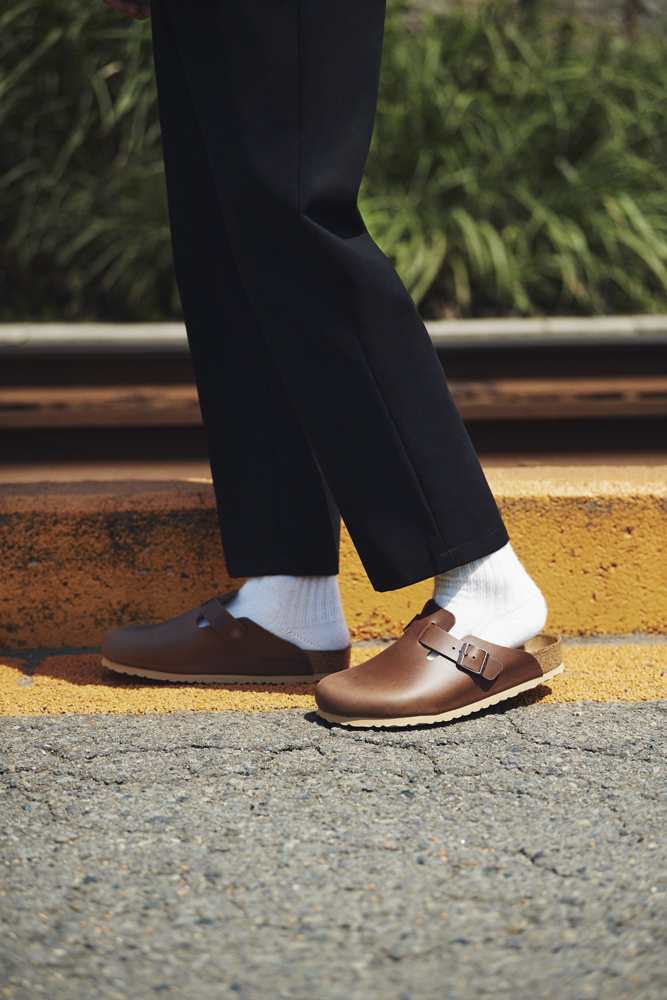 Minimalist lower body styling with tailored trousers and sandals