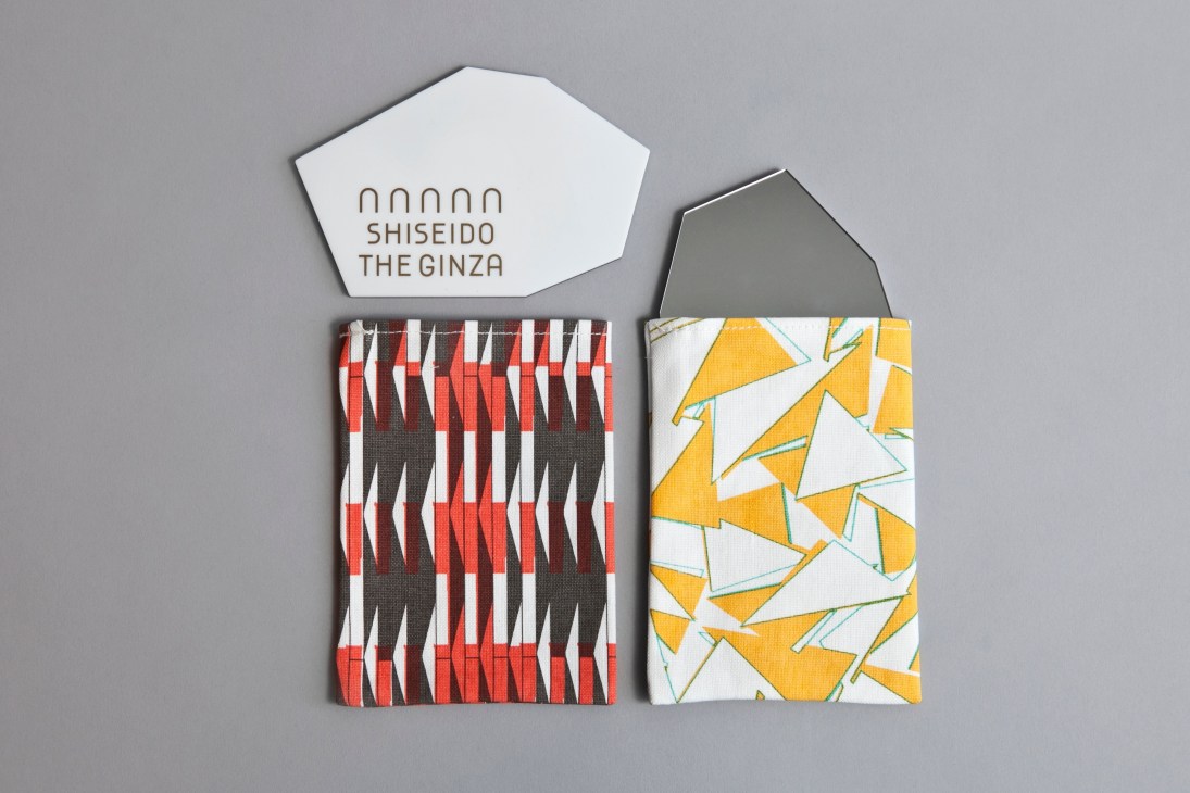 Shiseido limited-edition mirrors with patterned cotton cases in red and yellow geometric designs.