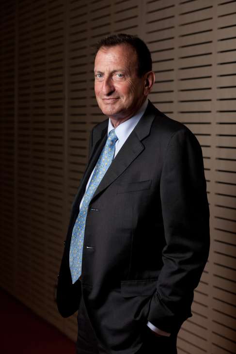 Ron Huldai, Mayor of Tel Aviv, wearing a dark suit and patterned blue tie.