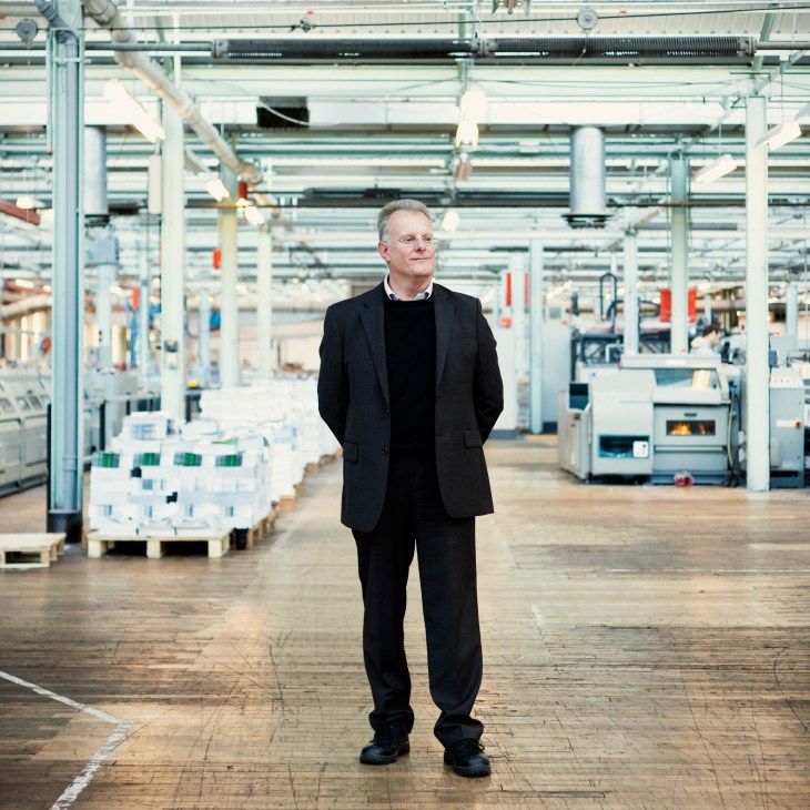Steve Burry, production director at Butler Tanner & Dennis, stands in an industrial printing facility.