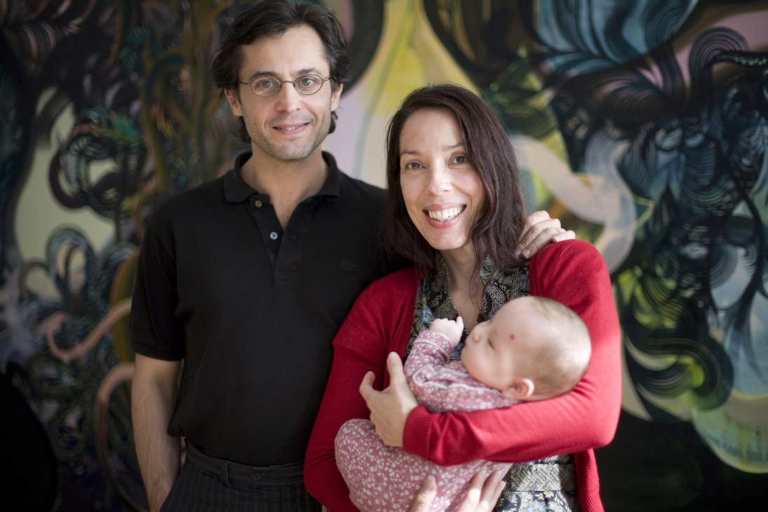 Catalin Enache, Hadassah Emmerich and daughter Ileana posing together against colorful street art.