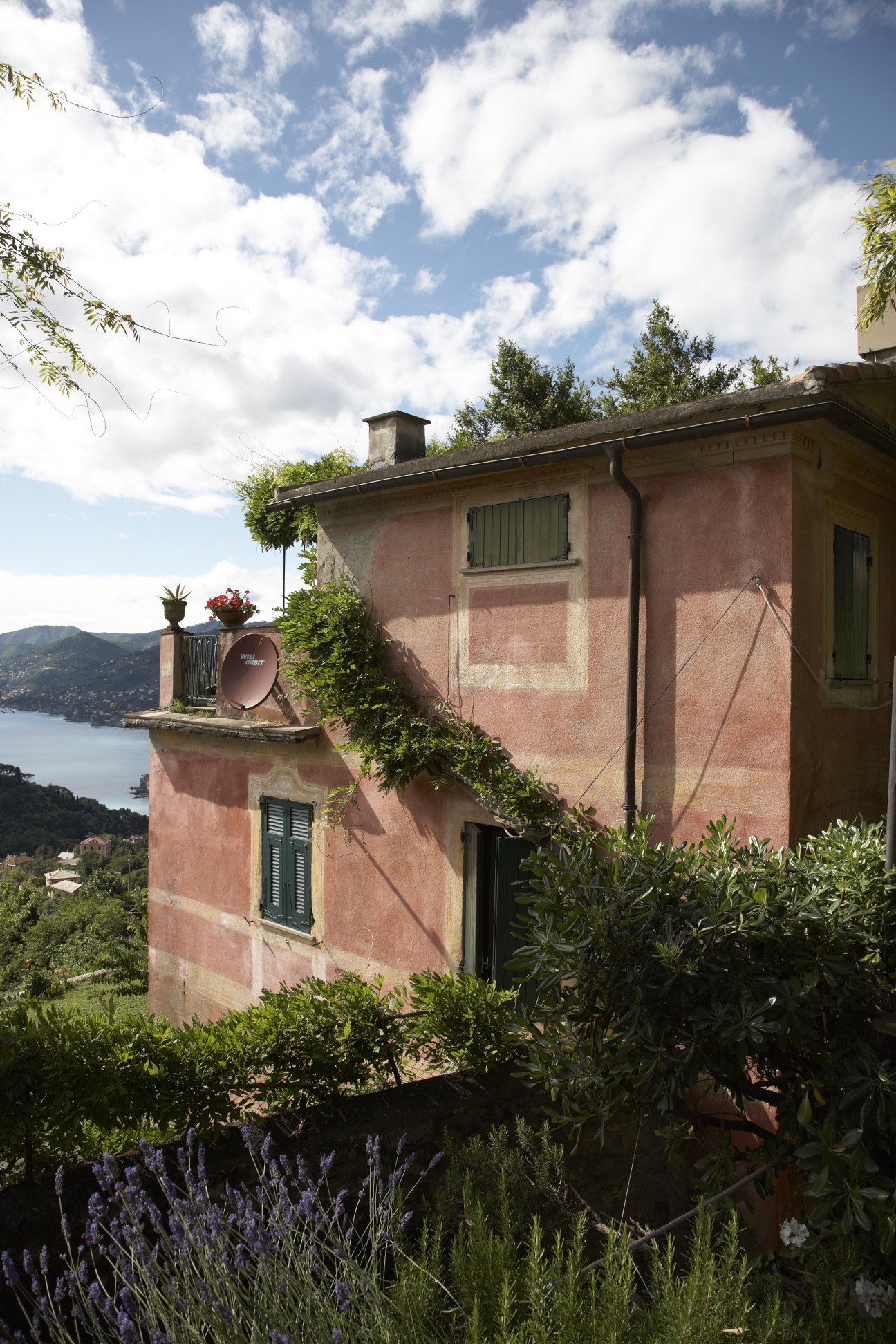 Pink restored mansion in Boschetto with garden overlooking Ligurian coastline and bay.