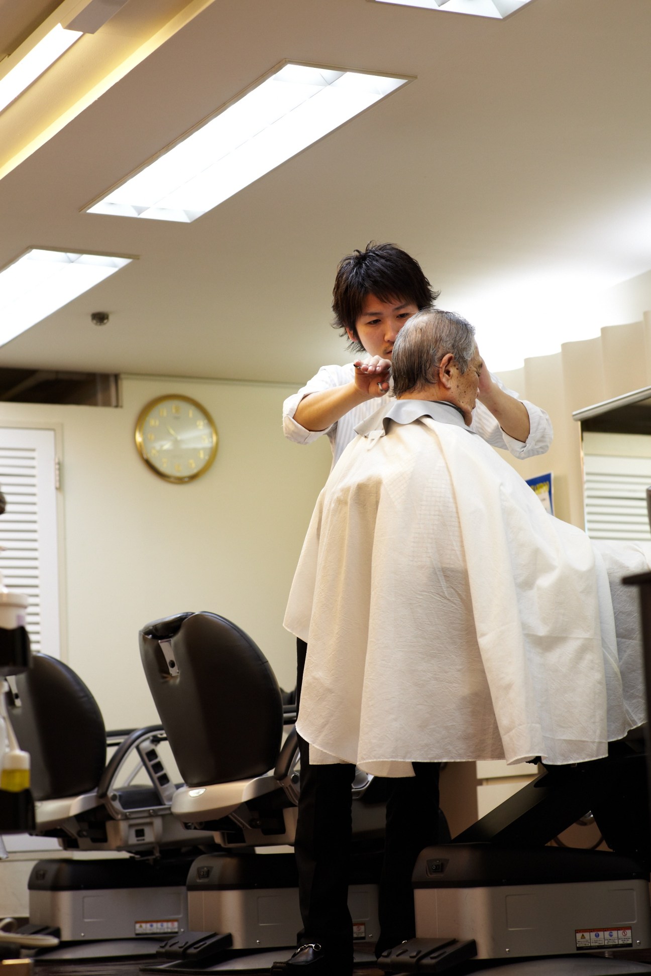 A barber cuts an elderly man's hair at Sky Salon in Tokyo.
