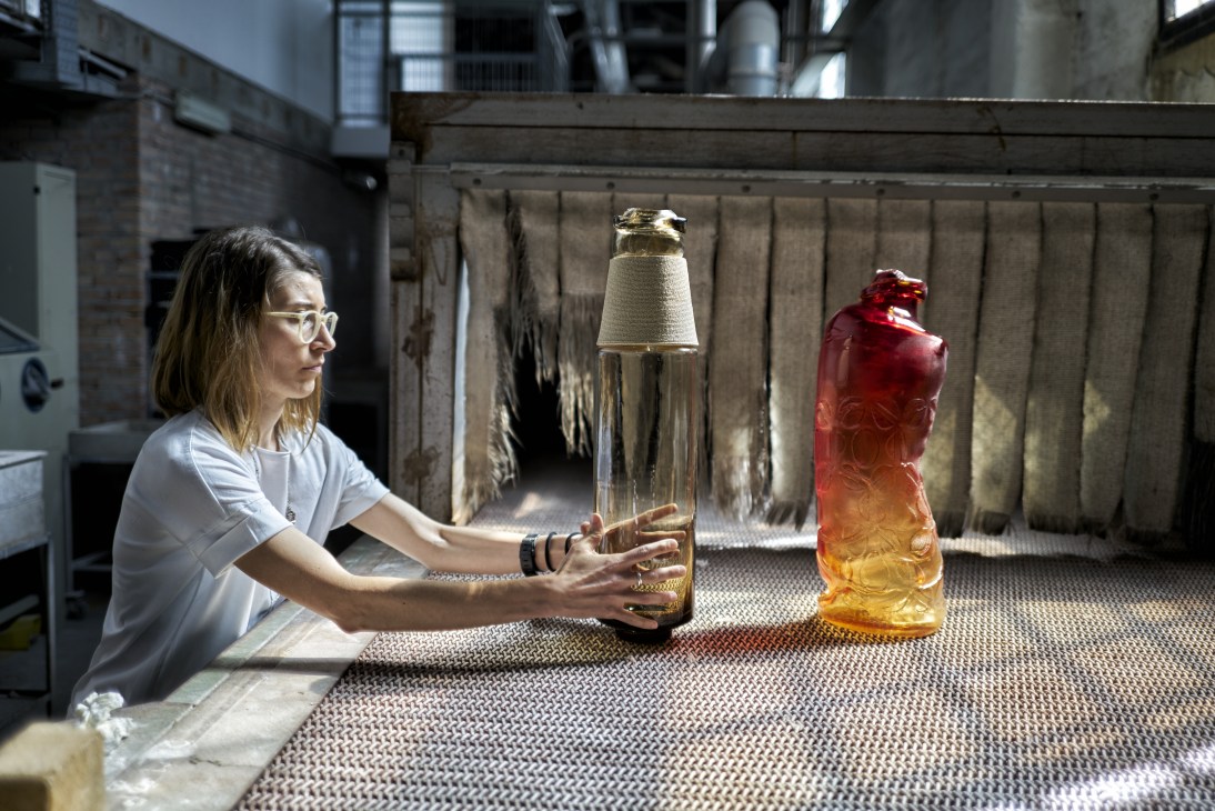 Designer Chiara Onida examines hand-blown glass vases in a Murano workshop.