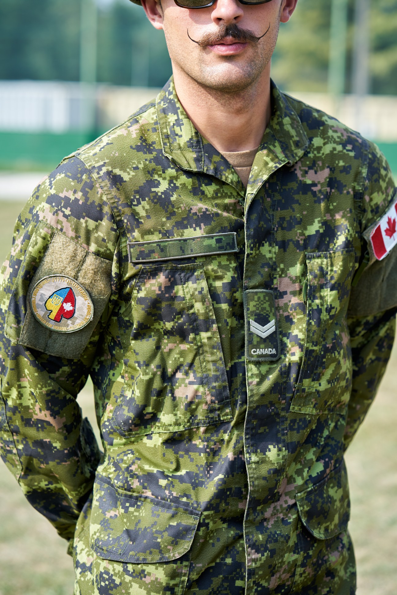 Canadian soldier wearing digital camouflage uniform with Operation Unifier badge combining Canadian and Ukrainian flags