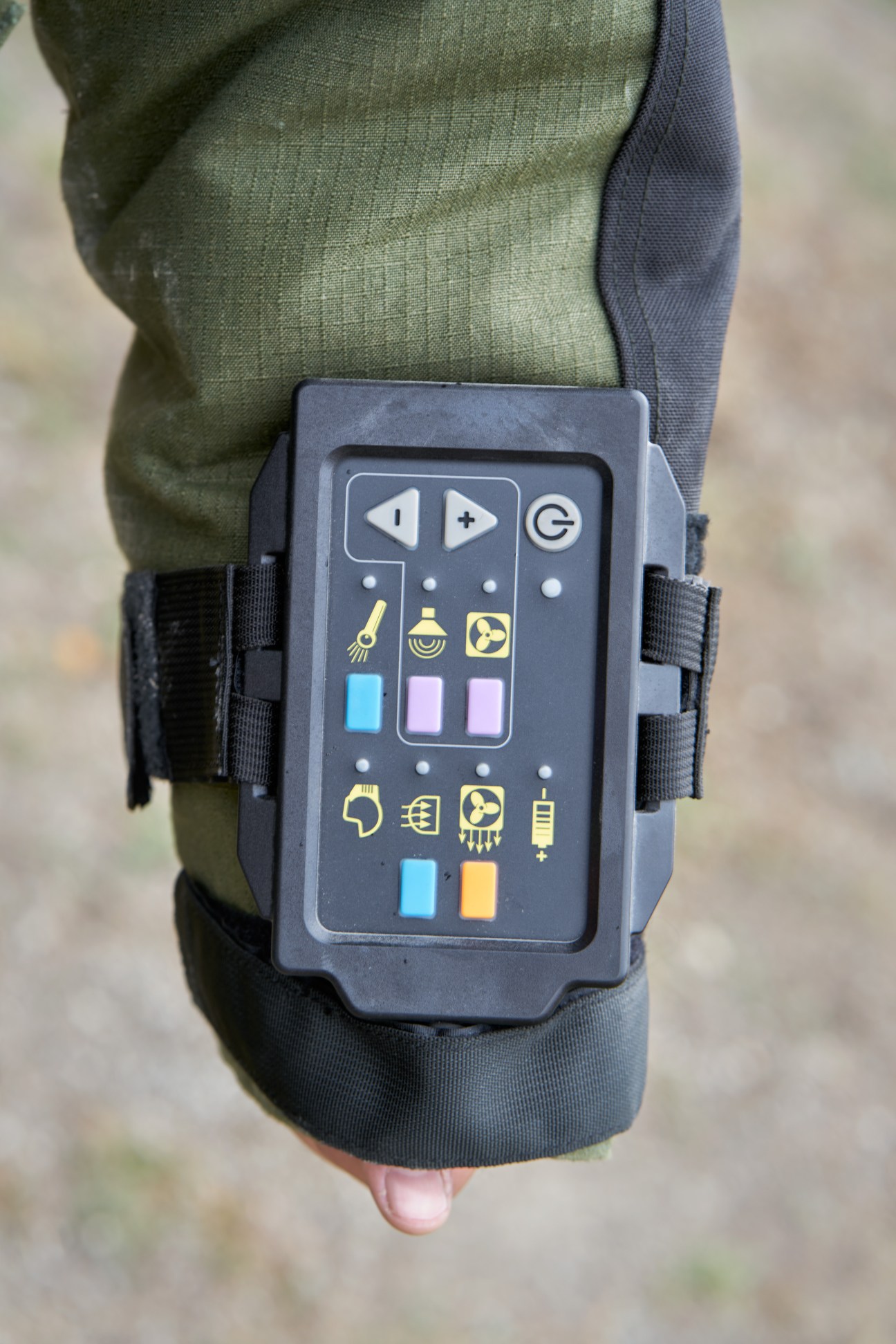 Electronic control unit with colorful buttons and icons mounted on the sleeve of an EOD-9 bomb disposal suit