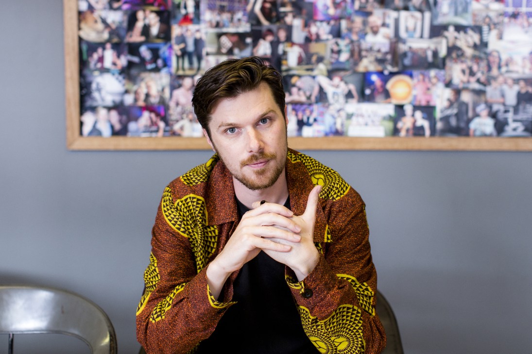 Marty Doyle, creative producer at FBI radio station, wearing a patterned jacket with yellow and rust tones.