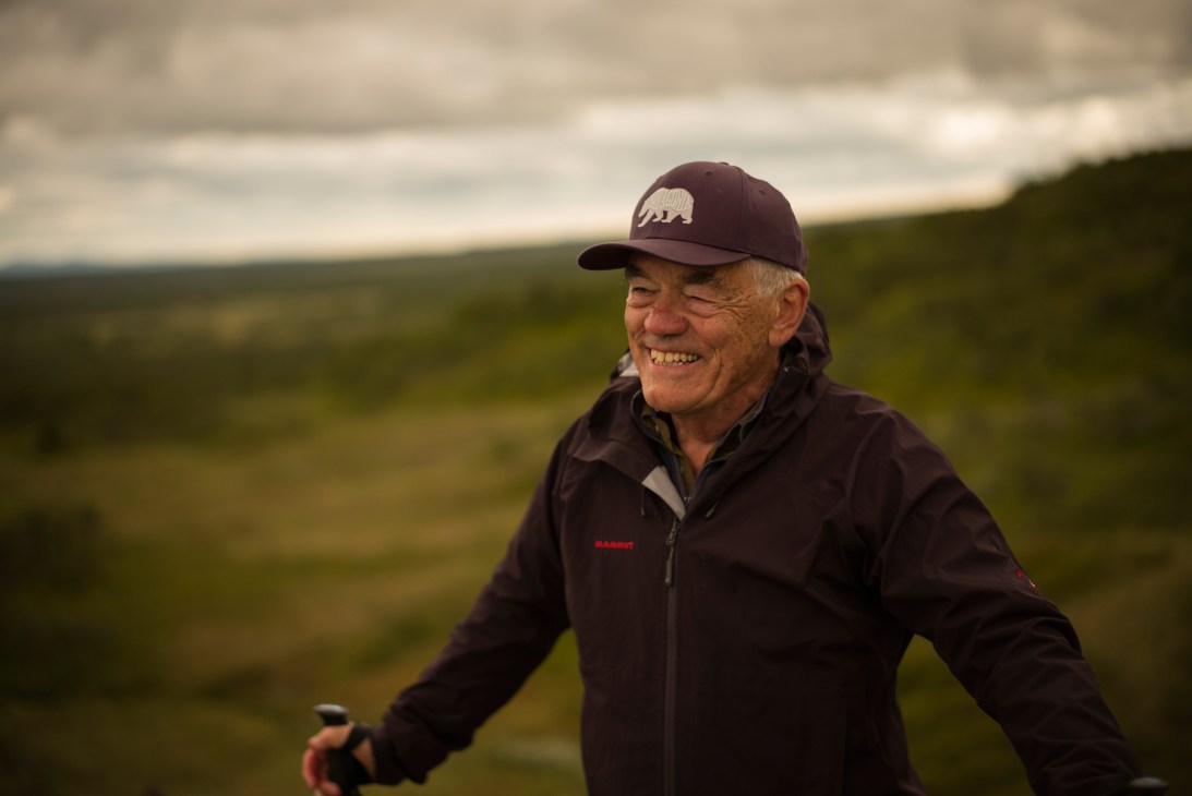 Bo Hilleberg, founder of Hilleberg, smiling outdoors in Swedish mountains wearing a dark jacket and cap.