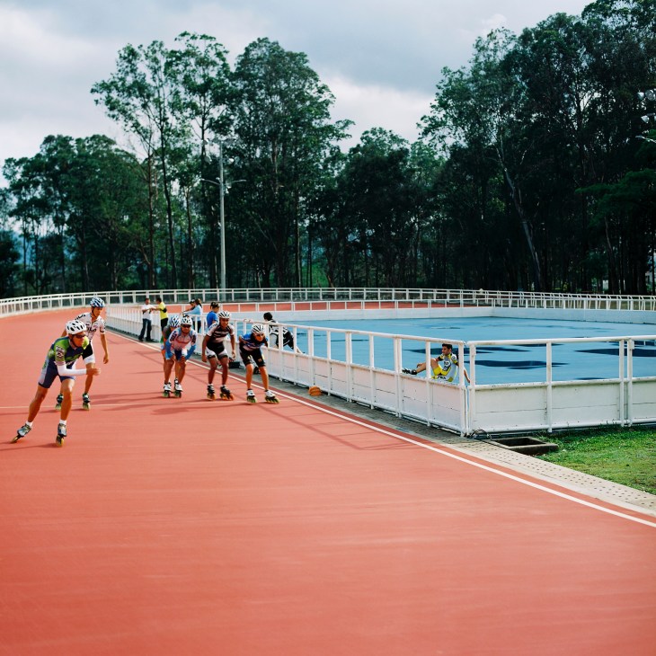 Costa Rica's national speedskating team training on an orange track during an early-morning session.