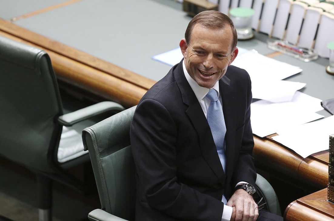 Tony Abbott seated in Parliament House wearing a dark suit and blue tie.
