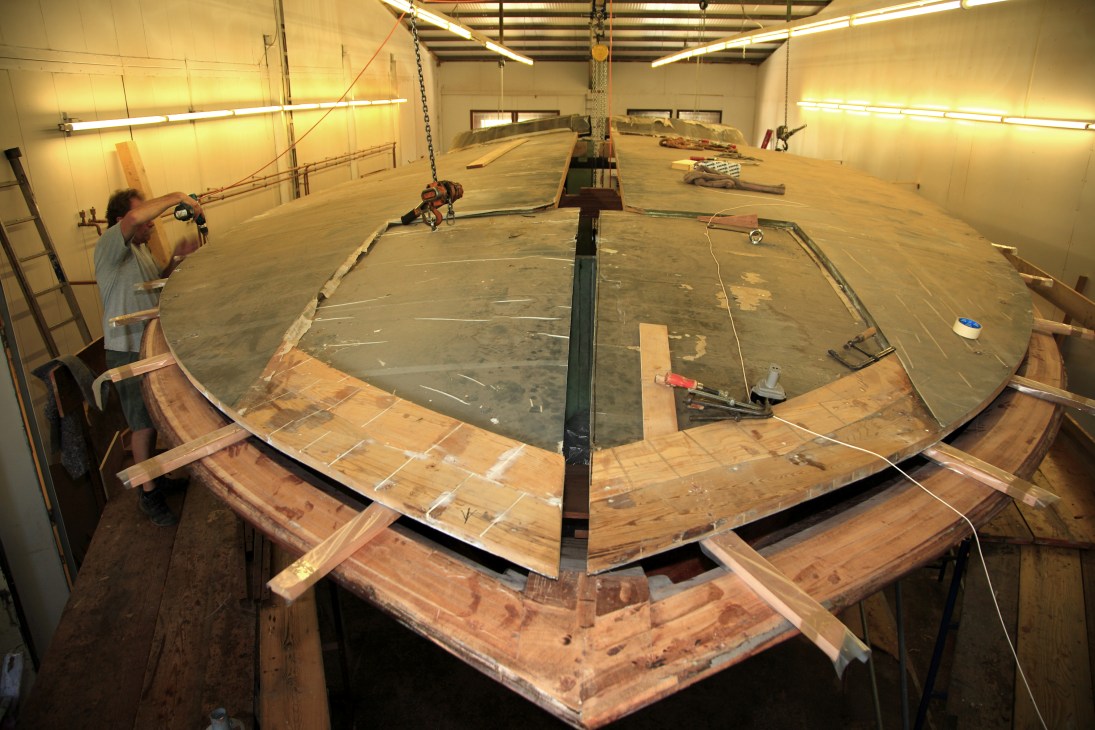 Aguti yacht hull under construction in shipyard, showing mahogany, carbon fibre and cedar materials.