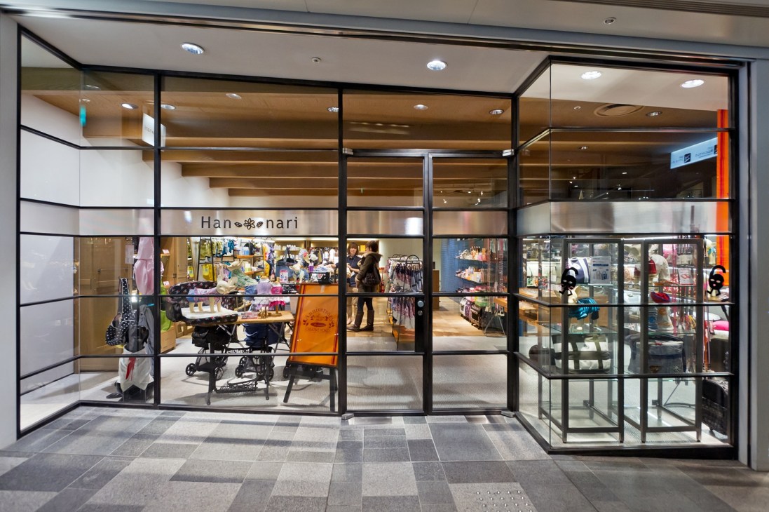 Hannari dog apparel store storefront with glass facade and interior displays in Omotesando Hills, Tokyo.
