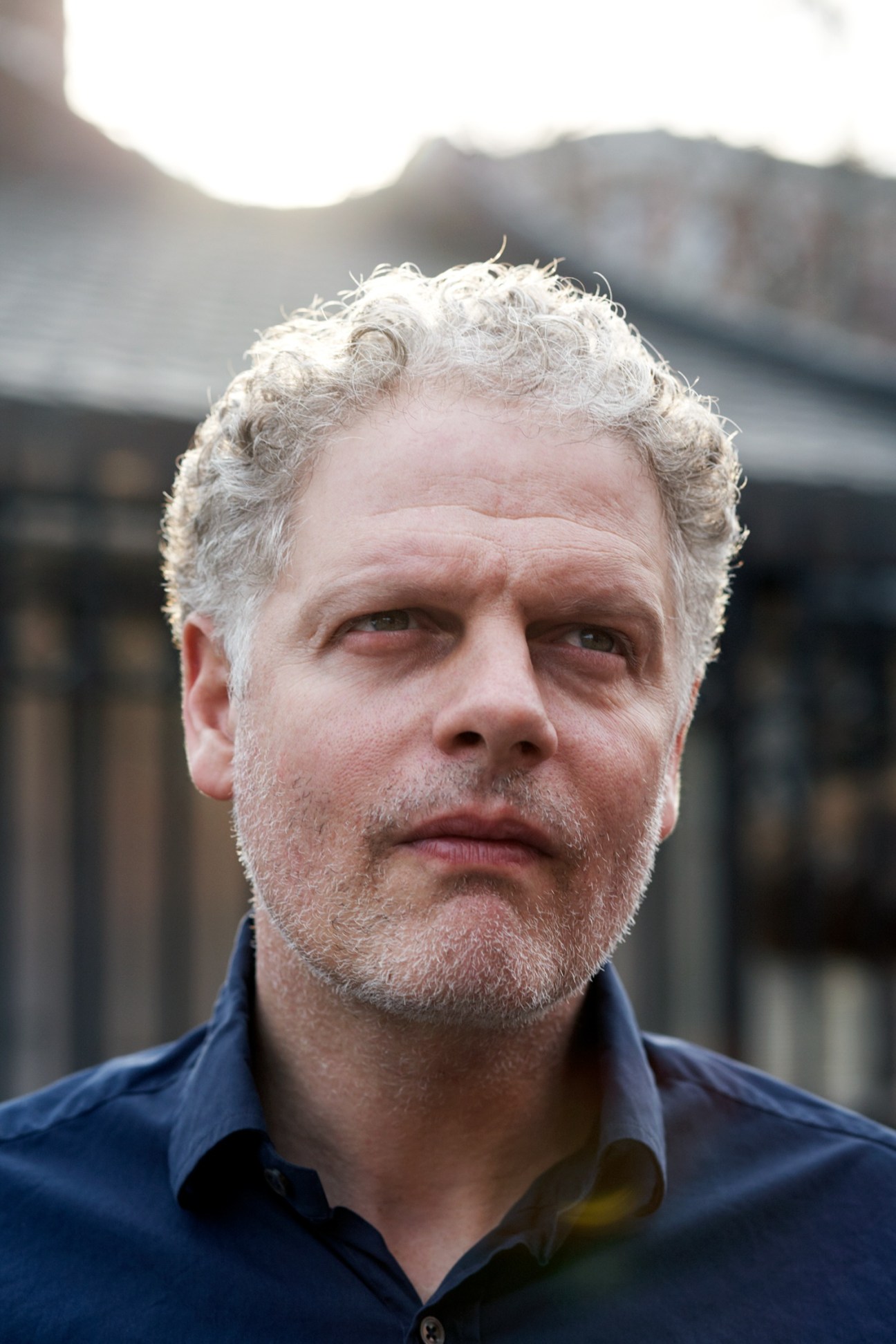 Portrait of Peter Ferraro, co-owner of East Village Radio, outdoors.