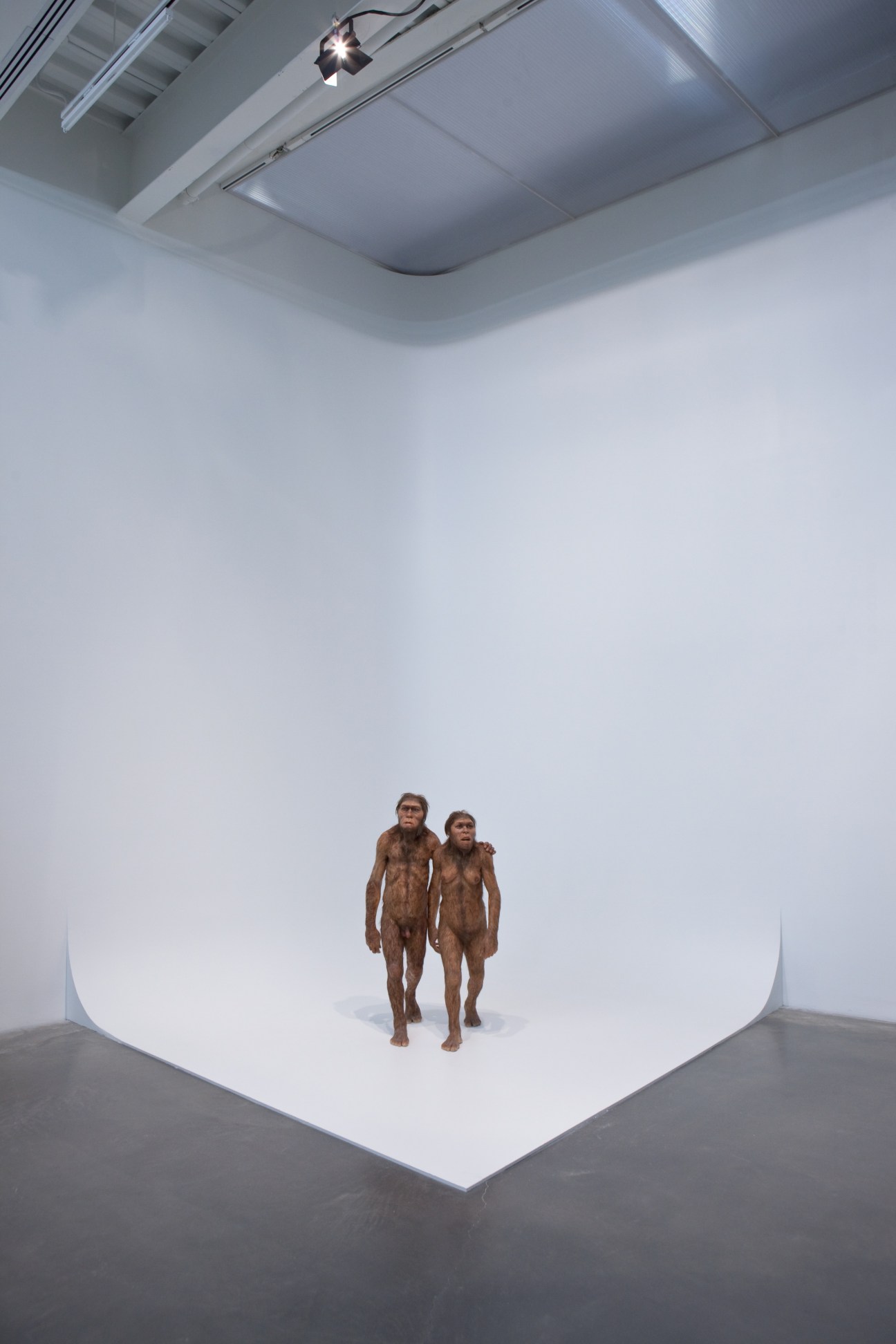 Tim Noble and Sue Webster's 'Masters of the Universe' sculpture featuring two figures in a minimalist white gallery space.