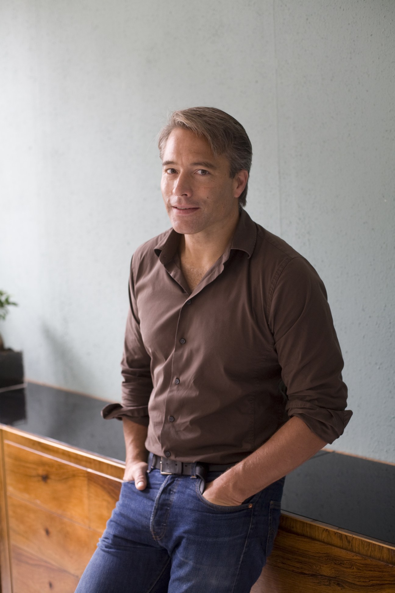 Portrait of Theo Ligthart, a 45-year-old local artist in Neukölln, wearing a brown shirt.