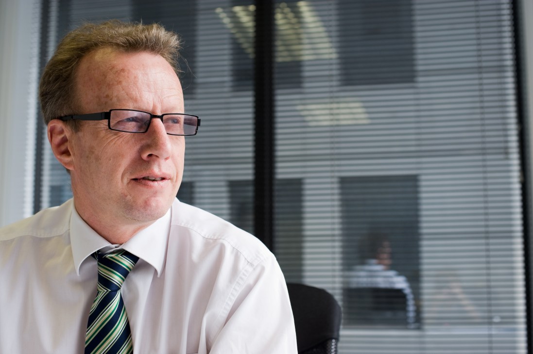 Dr Rick Boven, director of the New Zealand Institute, wearing glasses and striped tie in an office setting.