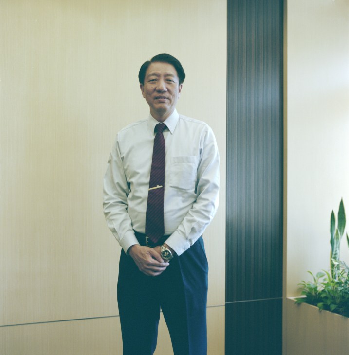 Deputy prime minister and minister for defence Teo Chee Hean standing in an office wearing a white shirt and dark tie.