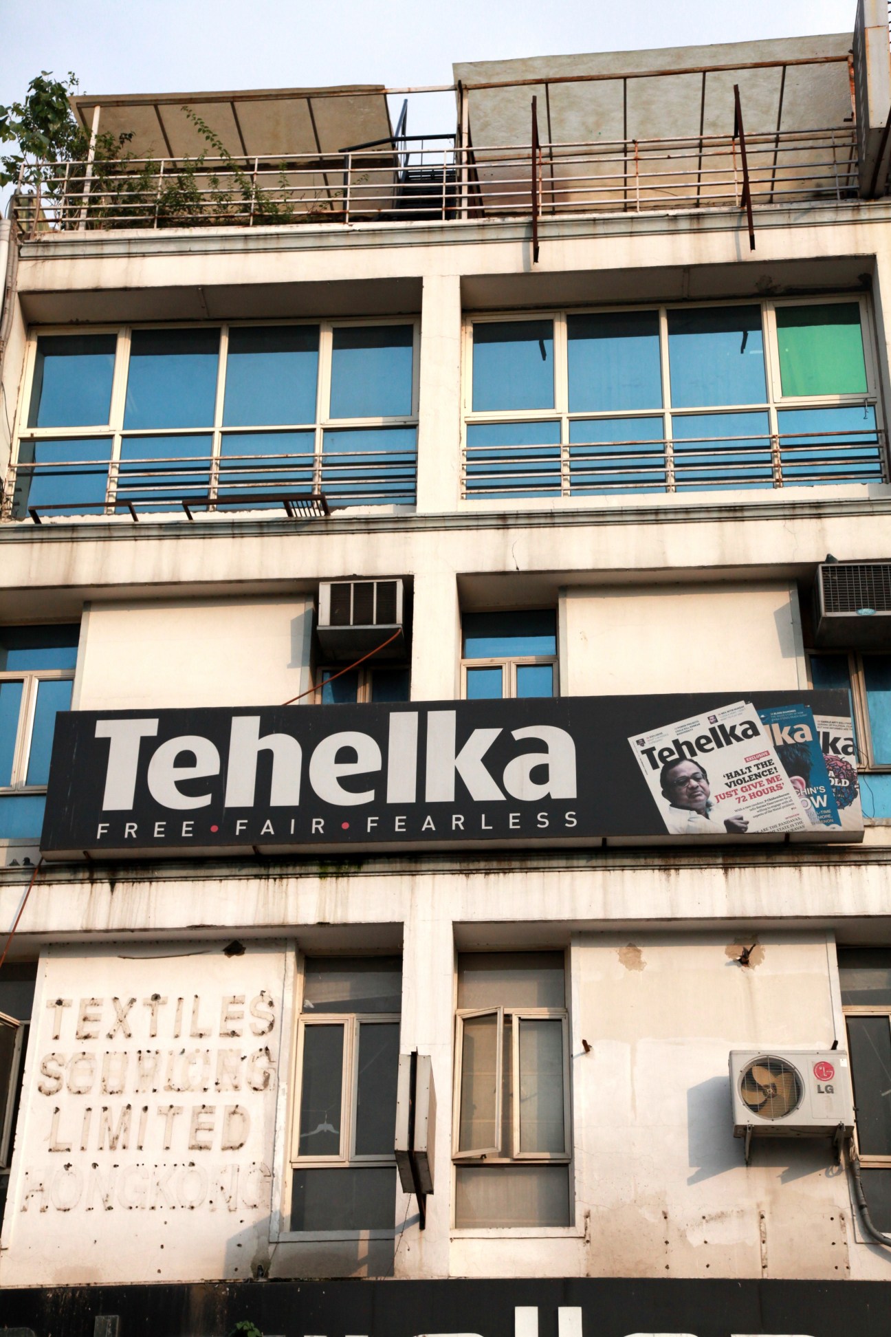 Tehelka magazine office building in New Delhi with signage reading 'FREE FAIR FEARLESS'